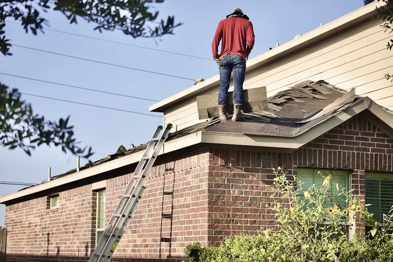 Professional roofer working on a residential roof in Needwood Estates